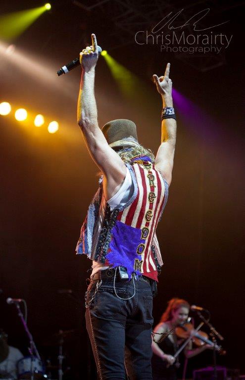 A Person Holding A Microphone And Pointing His Fingers Up